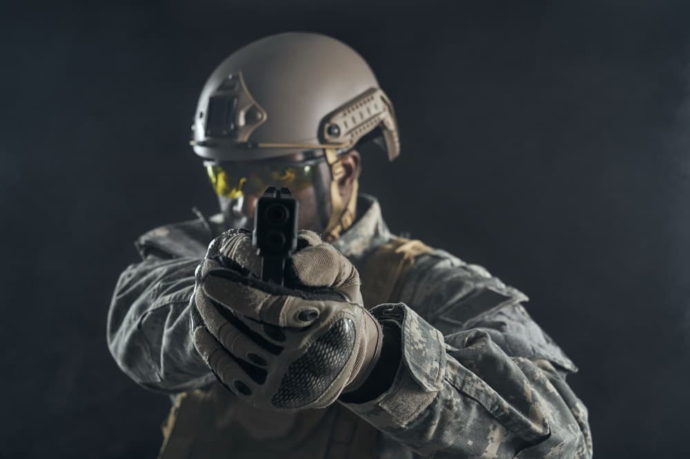 American soldier shooting at camera.