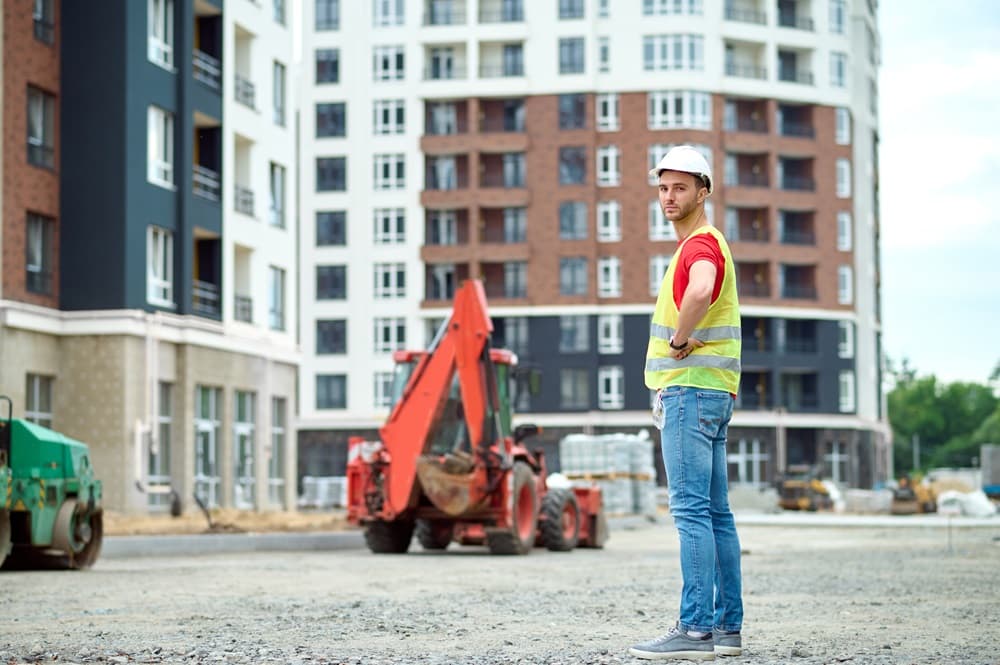 Man in protective helmet turning head towards camera